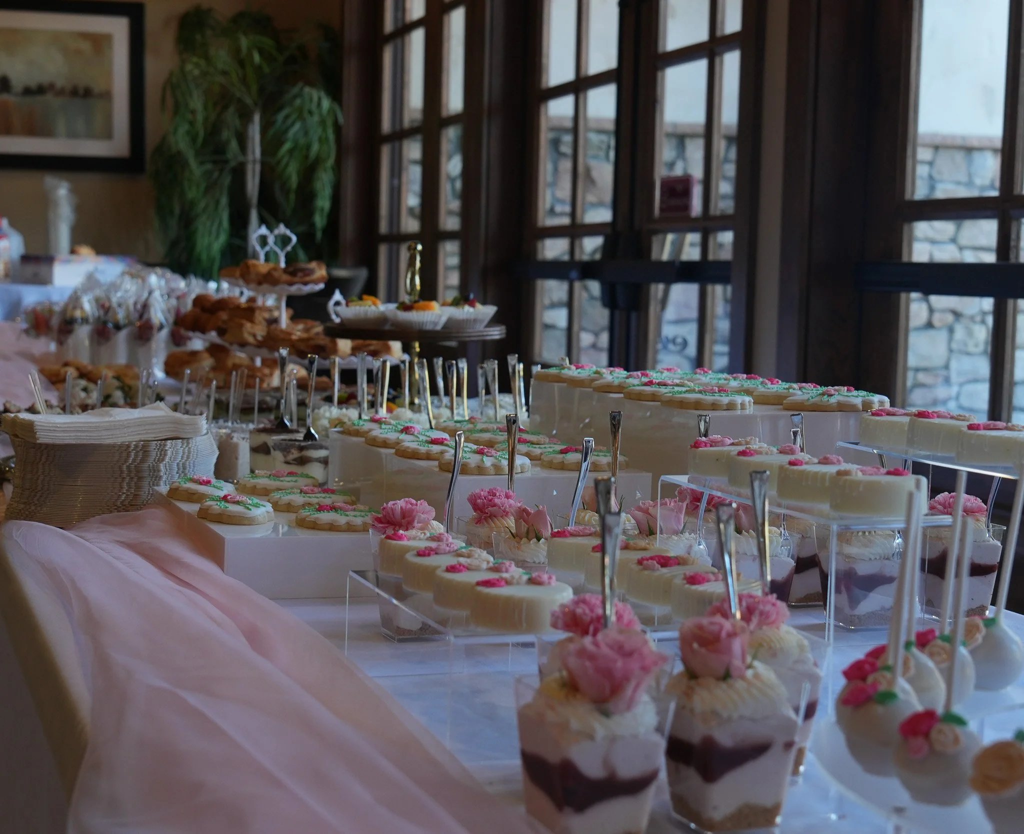 Dessert table with decorated cookies and roses