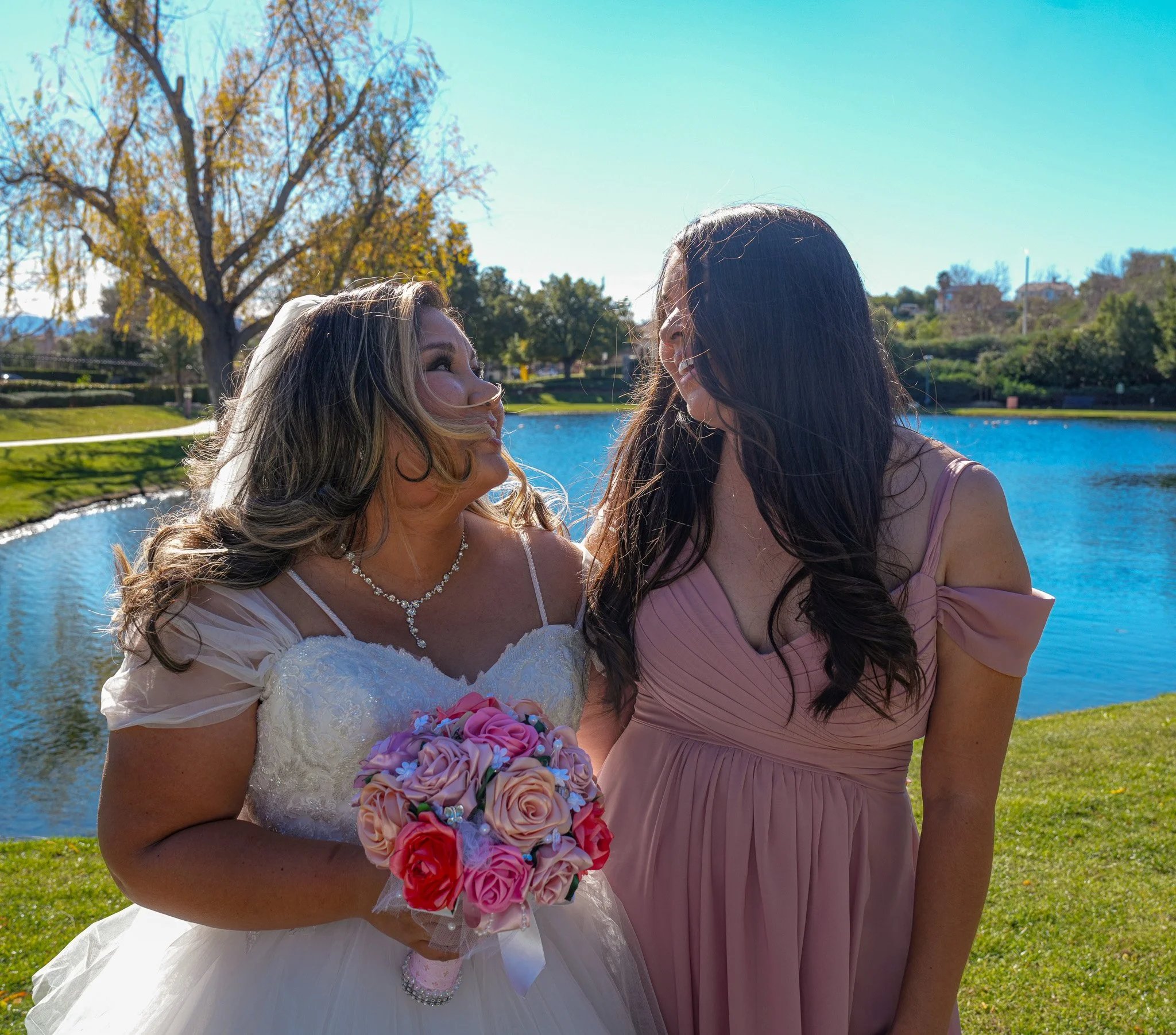 Bride with bouquet by a pond