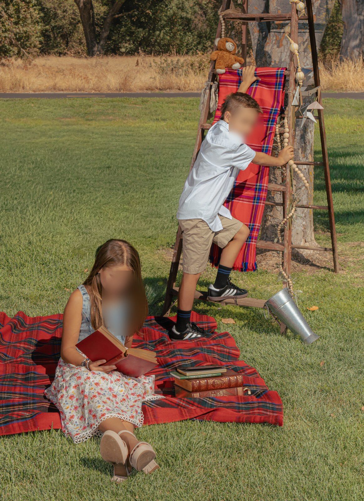 Children climbing a wooden ladder beside a plaid picnic blanket