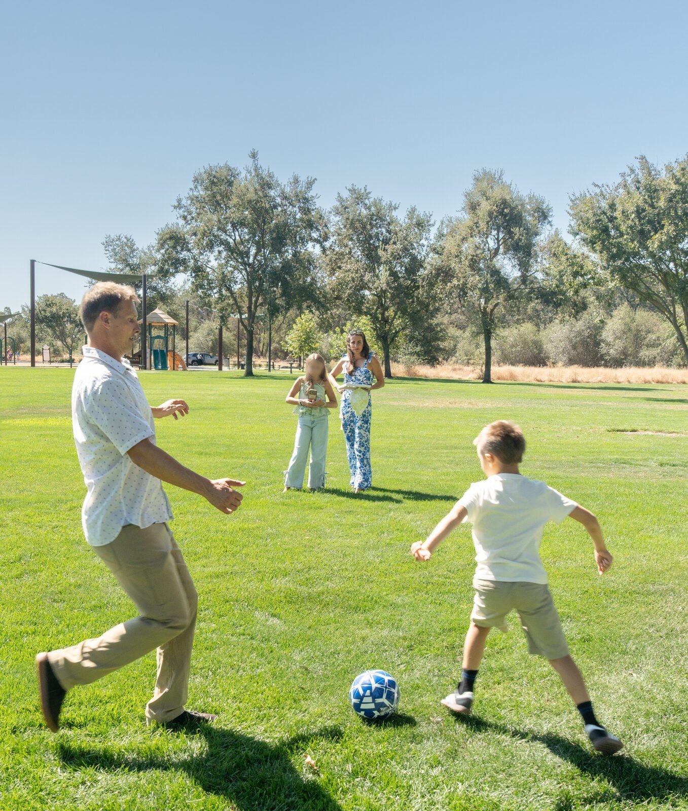 Kicking a football across an open green field